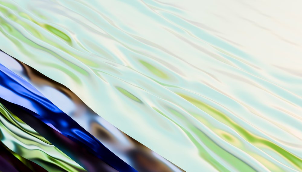 Abstract fluid texture featuring colorful waves and reflections forming a smooth liquid surface.