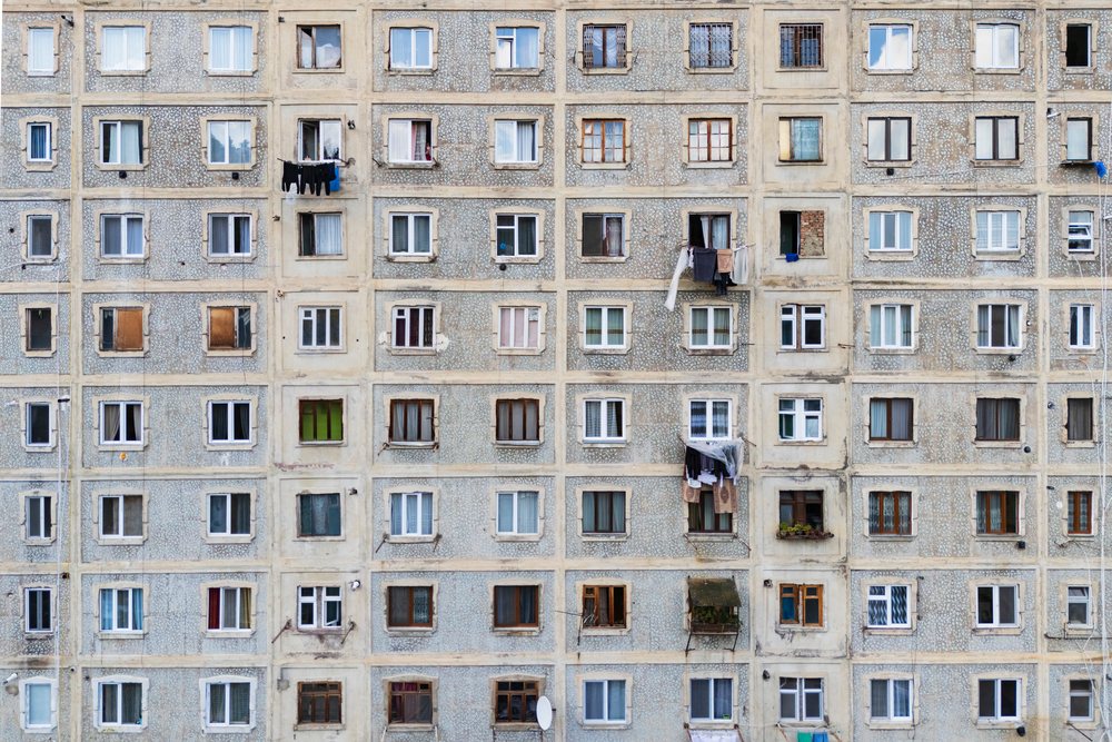 Multi-storey Soviet-style apartment building, with laundry hanging on lines and weathered concrete facade, Borjomi, Georgia.