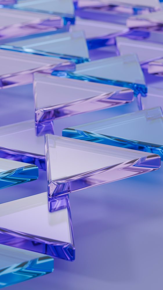 Abstract digital illustration of multiple blue and purple transparent glass triangles arranged in a geometric pattern on a smooth surface.