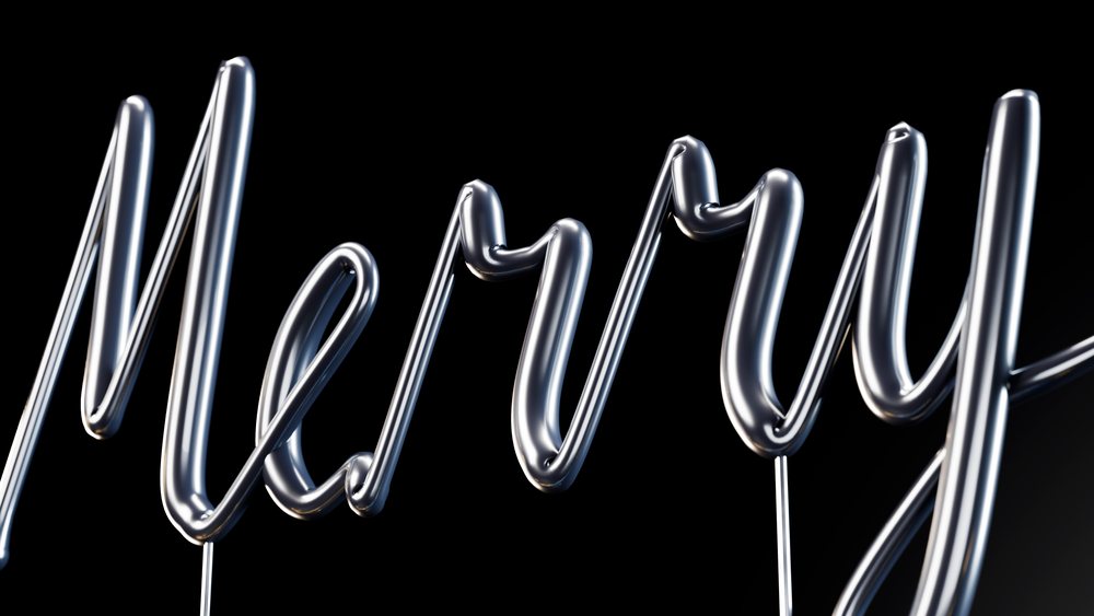 Silver metallic foil balloon letters spelling 'Merry' floating against a black background in a festive celebration decoration.