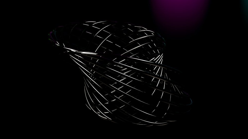 Metal spiral sculpture with reflective rings against a dark background under studio lighting.