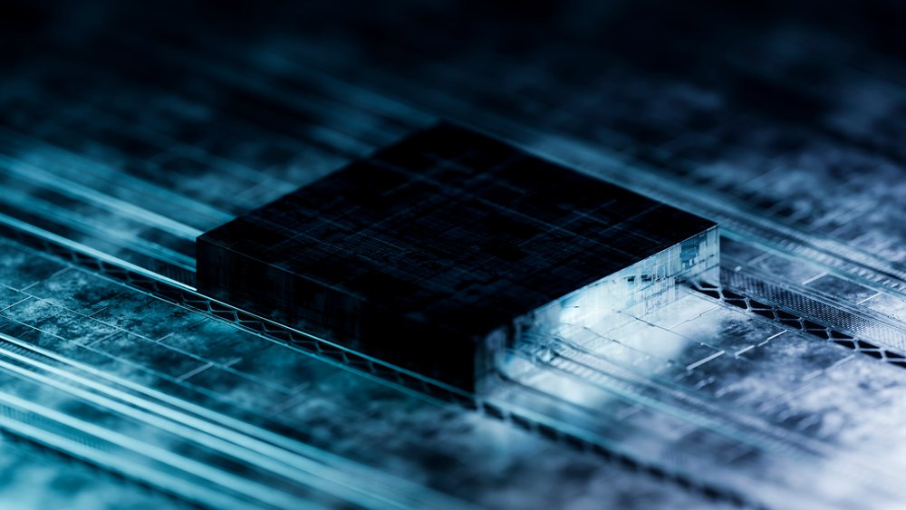 Close-up of a microchip on a circuit board illuminated with blue light representing digital technology.