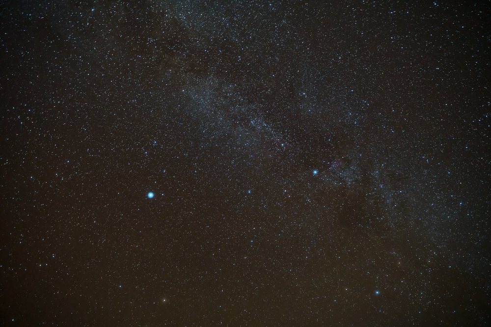 A stunning starry night sky with a visible galaxy over the Maldives