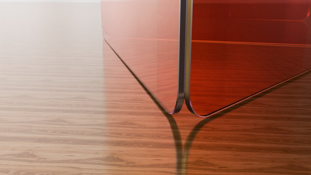 Close-up of red glass panel corner reflecting on wood floor with smooth surface and shadow.