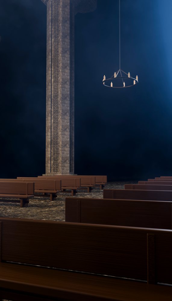 Interior of a church showing rows of wooden pews, a large stone column with carvings, and a hanging circular candle chandelier against a dark background.