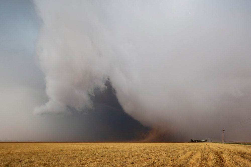 Large storm cloud with visible tornado formation and dust over a harvested wheat field, Levelland, Texas, USA.