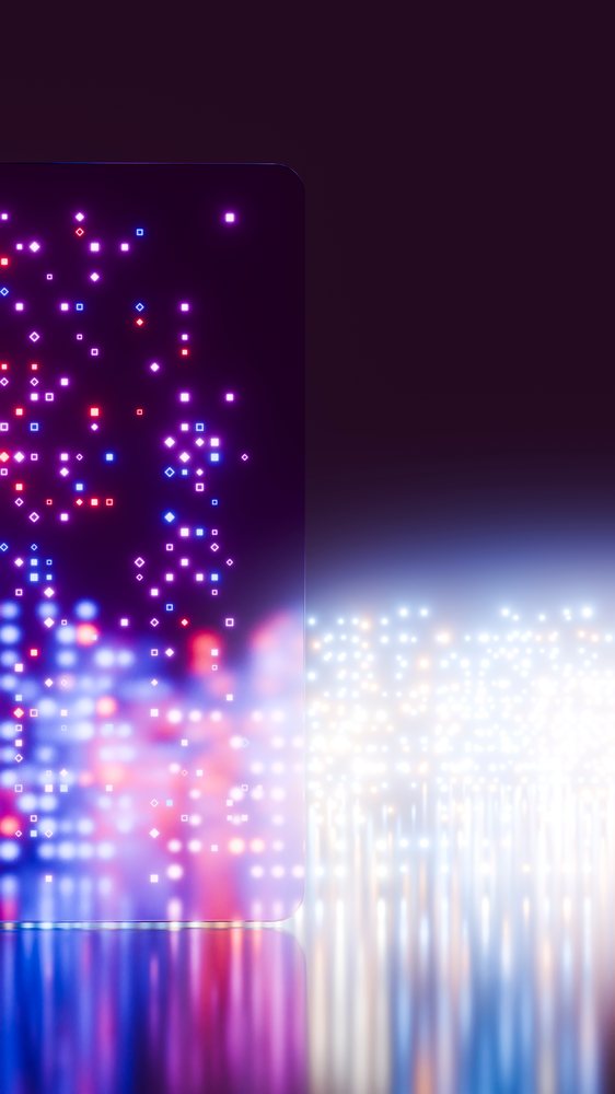 Rectangular digital screen with rounded corners displaying glowing red, blue, and purple dots arranged in a grid with their reflections on a smooth surface.