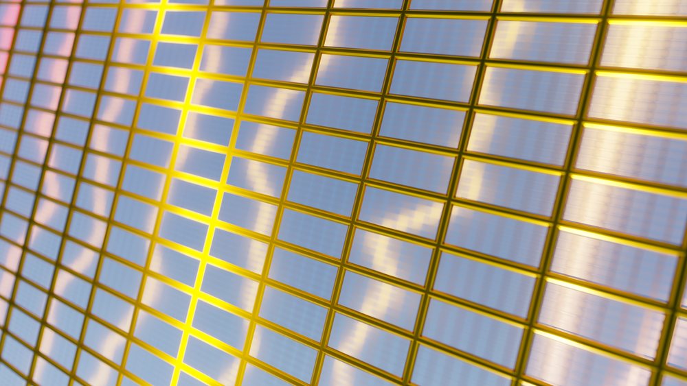 Quantum processor chip featuring a grid of quantum dots encased in a gold frame, illustrating advanced quantum computing technology.