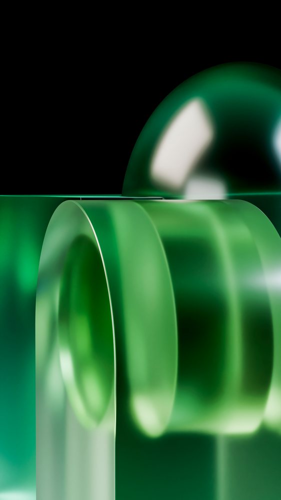 Digital illustration of transparent green glass sphere and cylinders with reflections on a black background.
