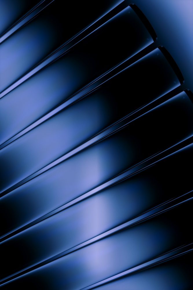 Close-up abstract view of smooth dark blue glass panes with reflective glossy texture and vertical alignment.