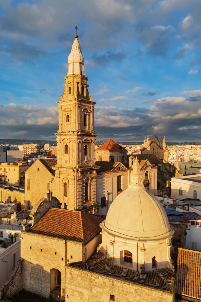 The Cathedral Basilica of Maria Santissima della Madia is shown, Monopoli, Puglia, Italy.
