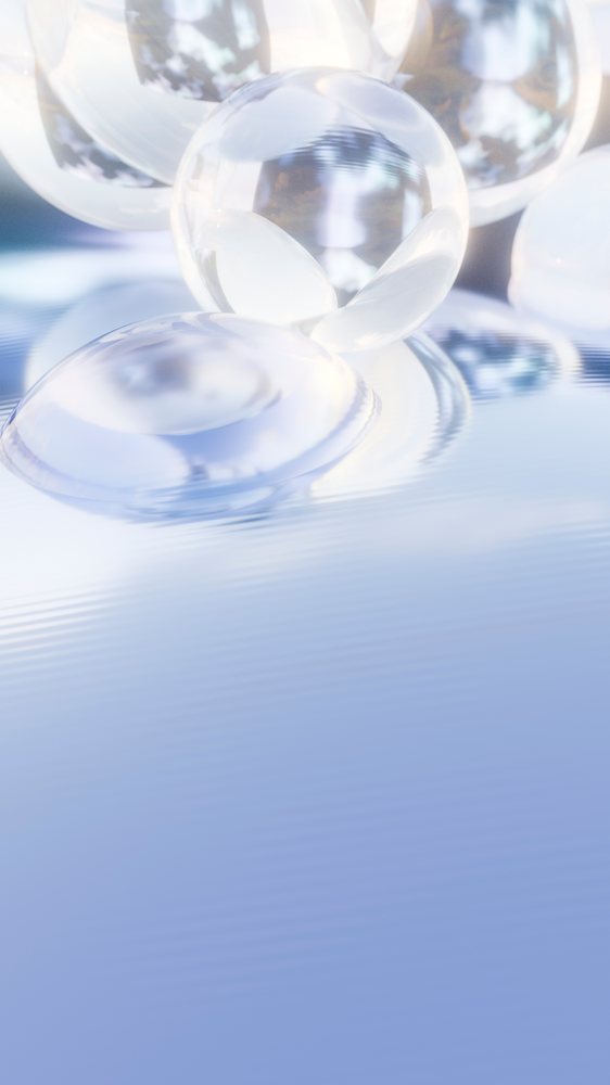 Transparent glass spheres float on a reflective water surface with ripples and light reflections against a blue background.
