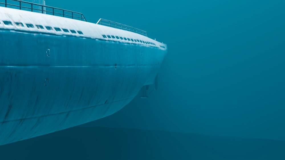 Submarine submerged underwater showing its metal hull and portholes in the ocean environment.