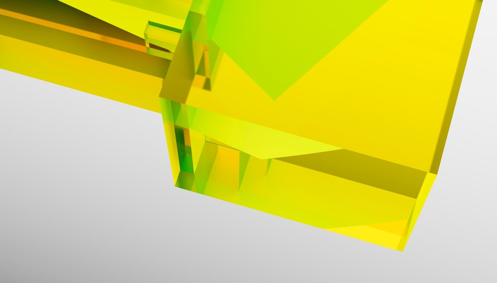Yellow transparent glass cube with geometric shapes on a light gray background.