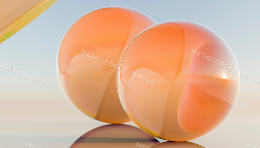 Two shiny orange spheres with reflective surfaces in a studio setting