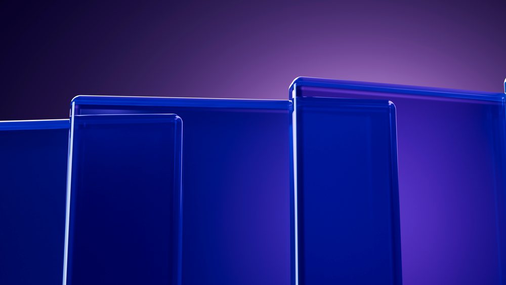 Blue glass panels with smooth edges arranged in an abstract geometric composition against a purple background.