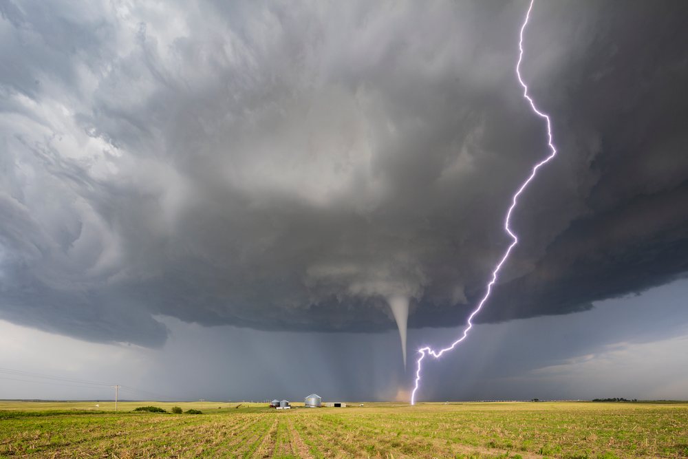 Tornado with Cloud-to-ground Lightning strikes over a rural field, Storm Chasing, Dickens, Nebraska, USA.