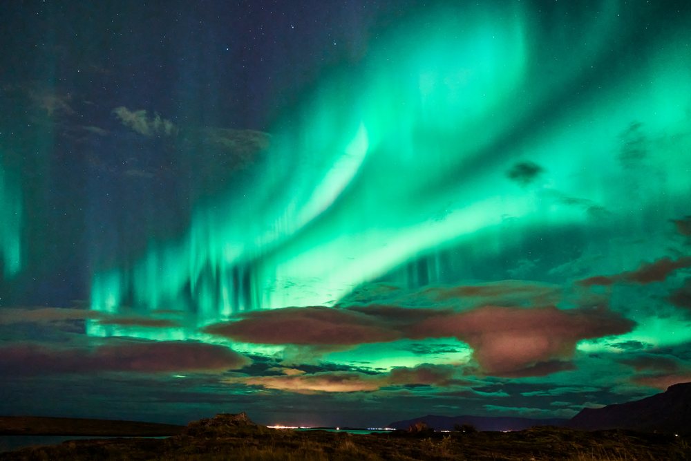 The northern lights illuminate the night sky over Iceland's landscape