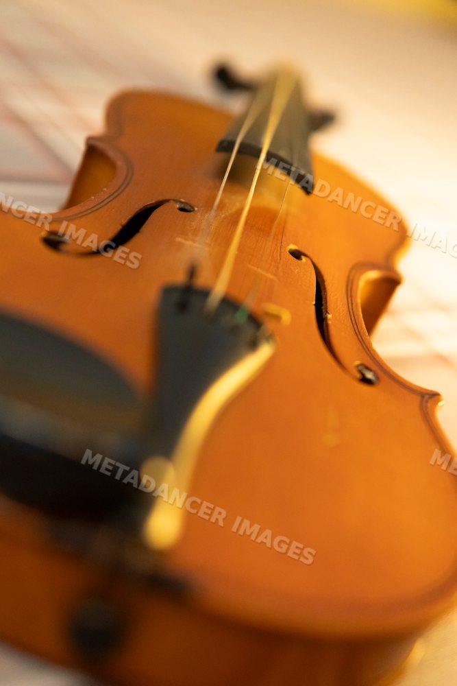 Close-up of a violin on sheet music with a warm retro tone in Verdun