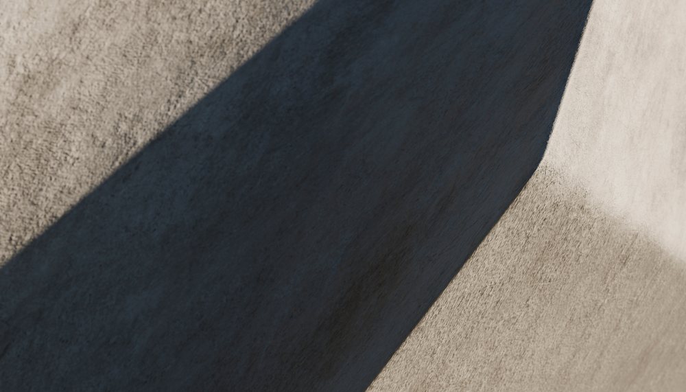 A concrete wall with curved shadow shapes and textured surface