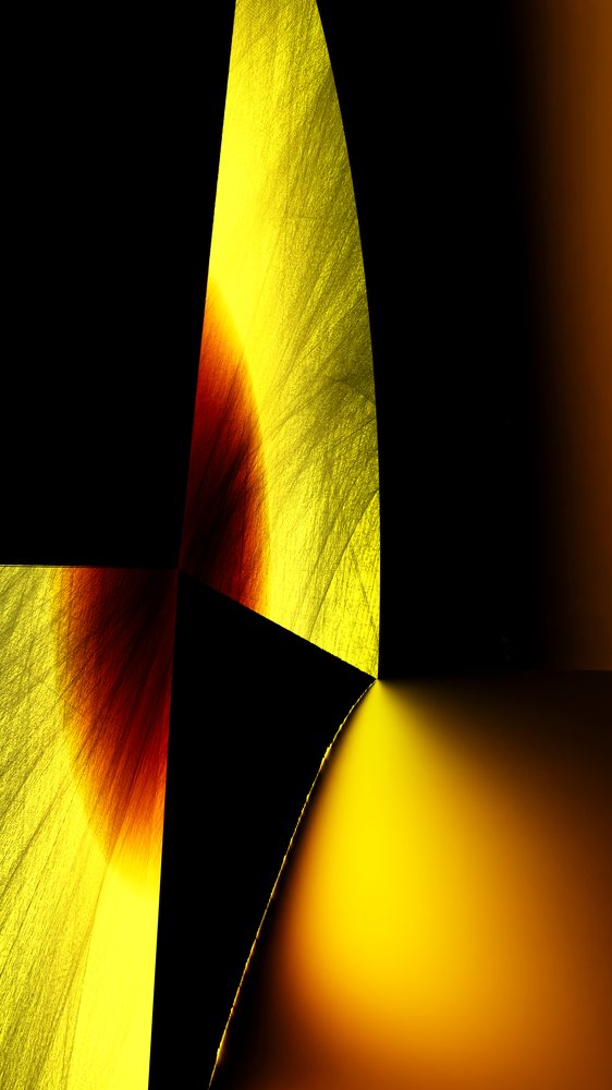 Abstract geometric shapes in yellow, black, and orange with gradient light and textured surfaces.
