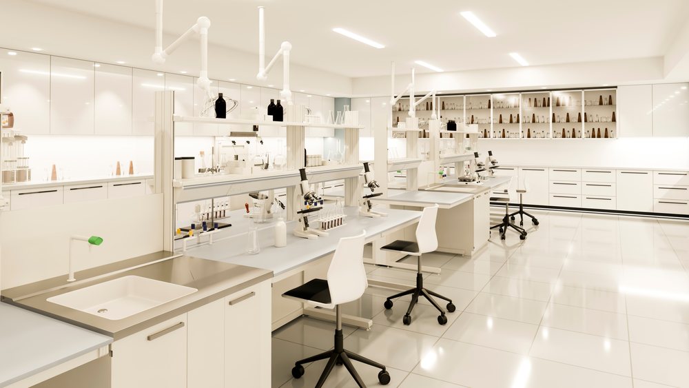 Modern laboratory interior with microscopes, test tubes, and laboratory glassware on benches and shelves.