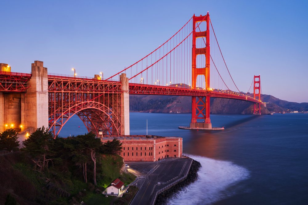 The Golden Gate Bridge with its lights on at Dawn, viewed from the Battery E Trail, landscape, cityscape, city life, San Francisco, California, USA.