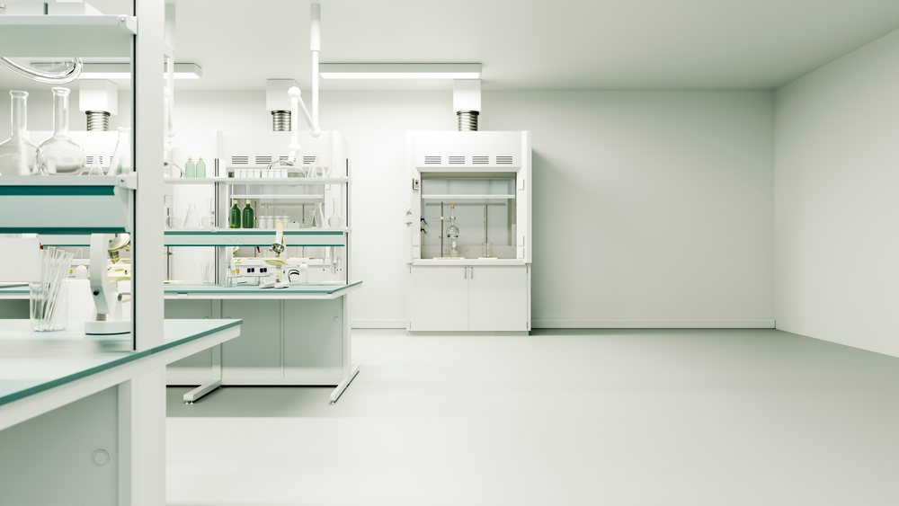 Laboratory interior with scientific instruments including microscopes, glassware, and a fume hood in a clean workspace.