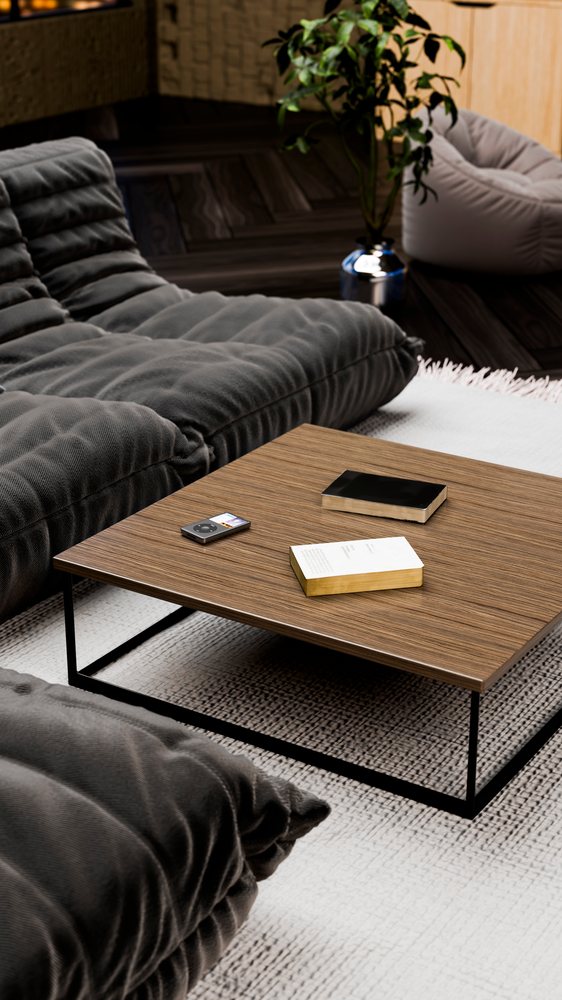 Modern living room featuring a wood coffee table with metal legs, gray tufted sofas with decorative pillows, a textured area rug, and an indoor leafy potted plant.