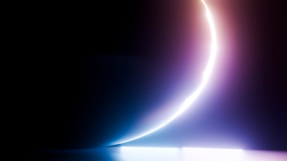 Glowing crescent light reflects purple and blue hues on a dark background in abstract digital art.