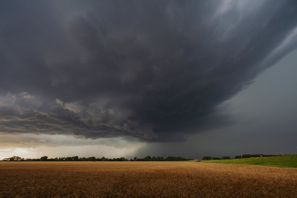 Tornado-warned supercell storm cloud forms over a wheat field, in the Midwest United States, Storm Chasing, Weather, Environmental Issues, Abilene, Kansas.