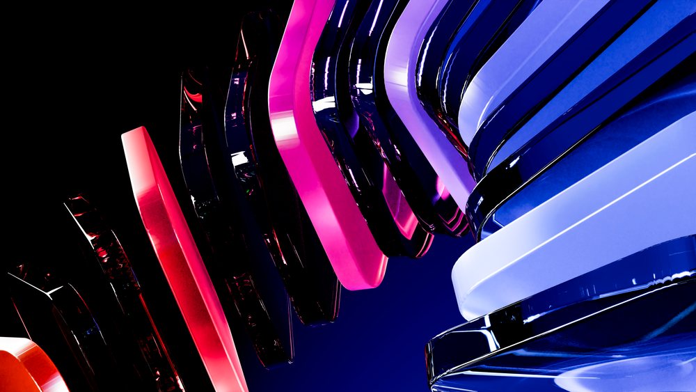 Glossy, colorful abstract 3D shapes layered in purple, pink, and blue tones against a black background.