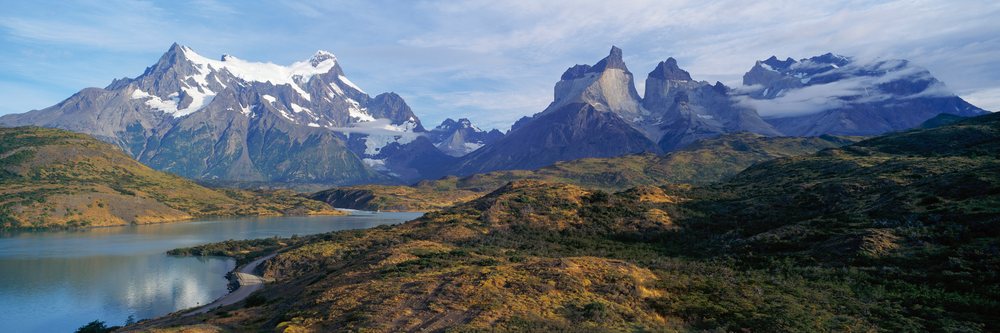 Mountain landscape with lake, hills, and clouds, Torres del Paine National Park, Chile.