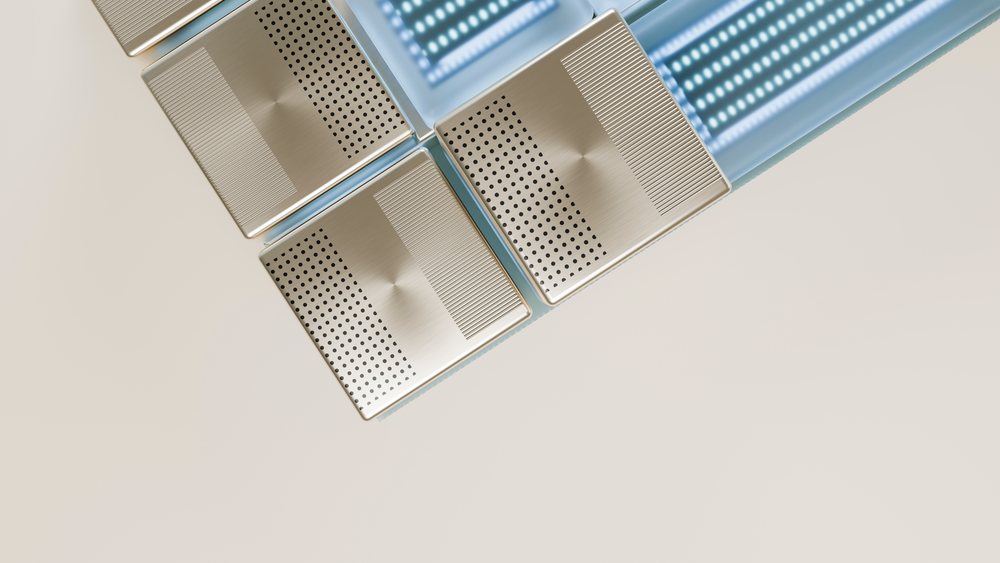 Square perforated metal tiles arranged alongside blue glass tiles on a beige background in a modern abstract geometric pattern.