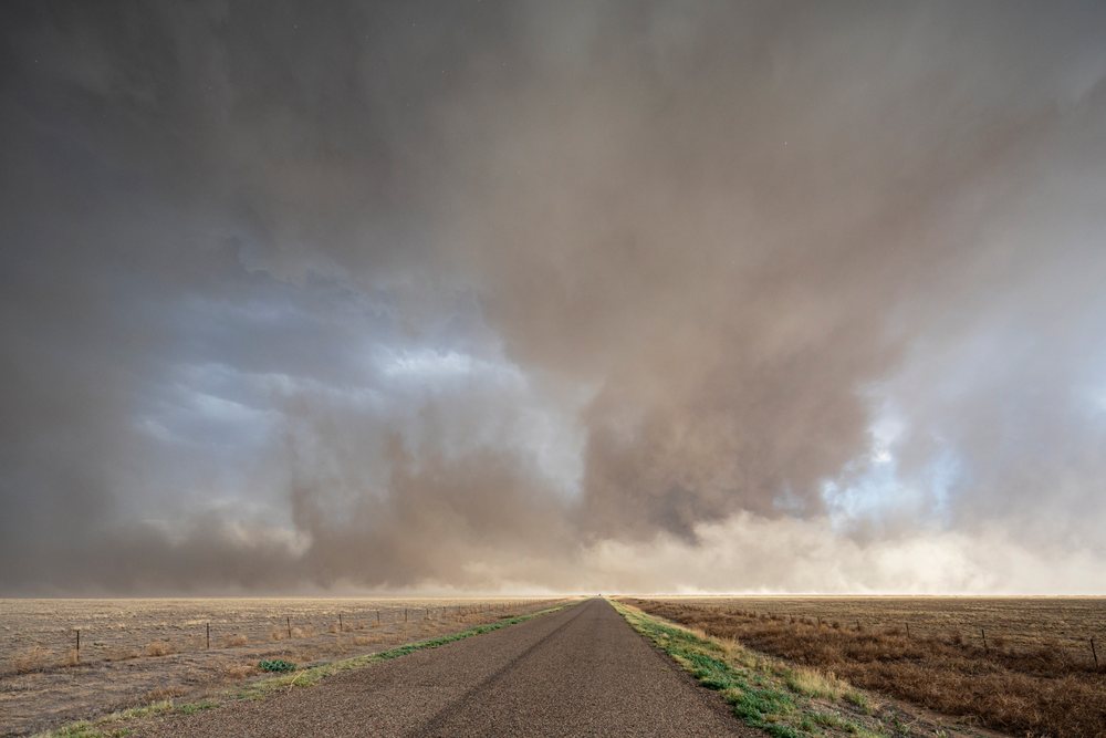 Approaching Haboob Dust Storm approaches over dry plains along County Road 2, under a dramatic stormy sky, Storm Chasing, Weather, Environment, Fowler, Colorado, USA.