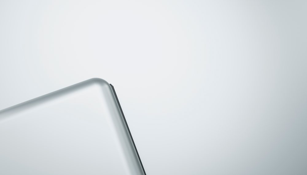 Corner of a silver laptop on a white background.