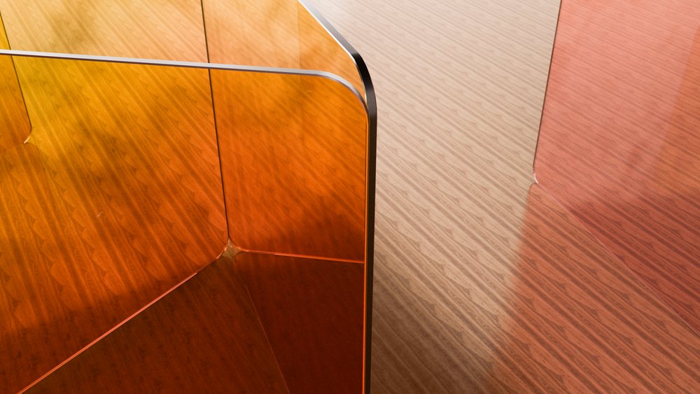 Orange acrylic panels with curved edges used as a transparent partition reflecting light on a wood floor in a modern interior space.