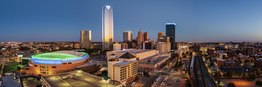 Dawn illuminates the Oklahoma City skyline with skyscrapers, roads, and modern downtown buildings under a clear sky, Americana, Historic, USA.