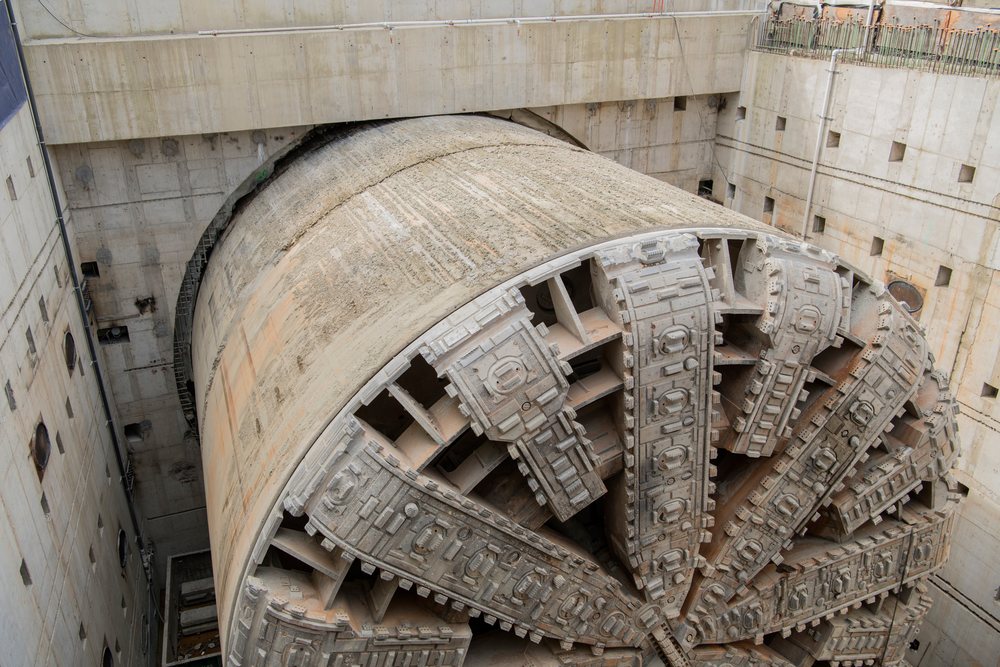 Large tunnel boring machine undergoing excavation behind concrete walls at a construction site, a large tunnel boring machine, drilling, USA.