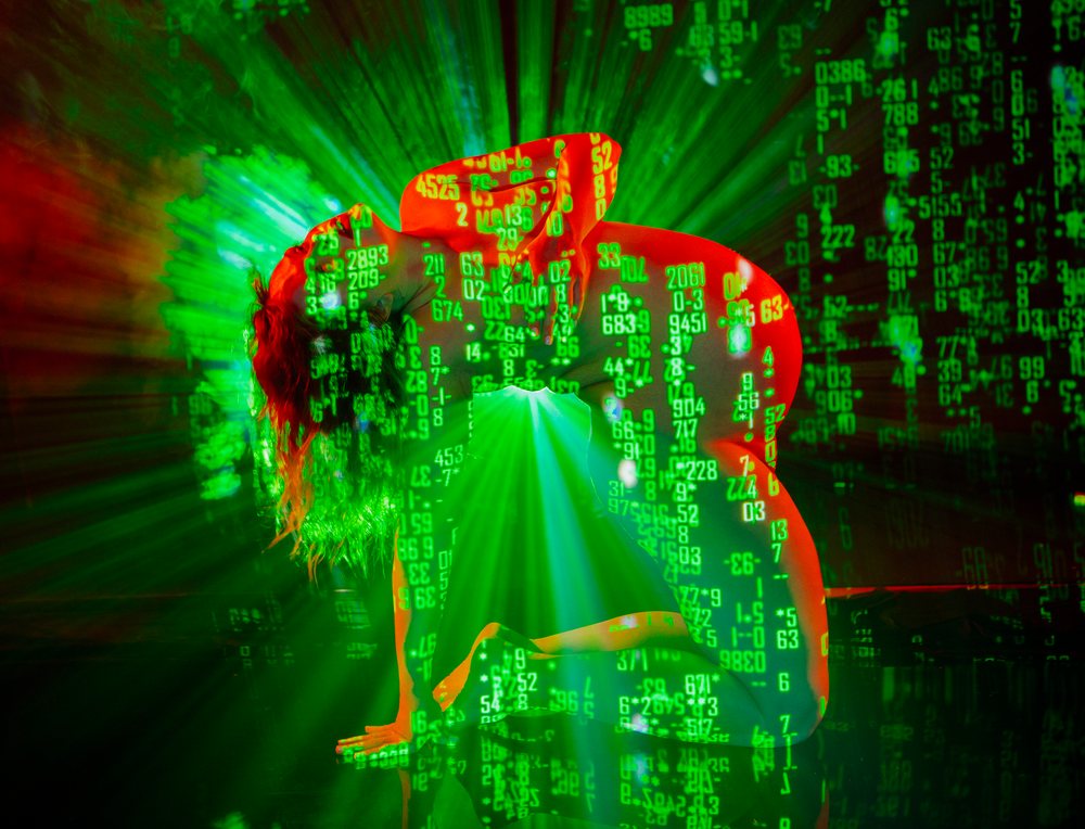 Woman kneeling in a dark space, pregnancy.