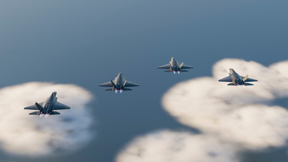 Four fighter jets fly in formation with afterburners active above clouds in clear sky, defense, war, security, military.