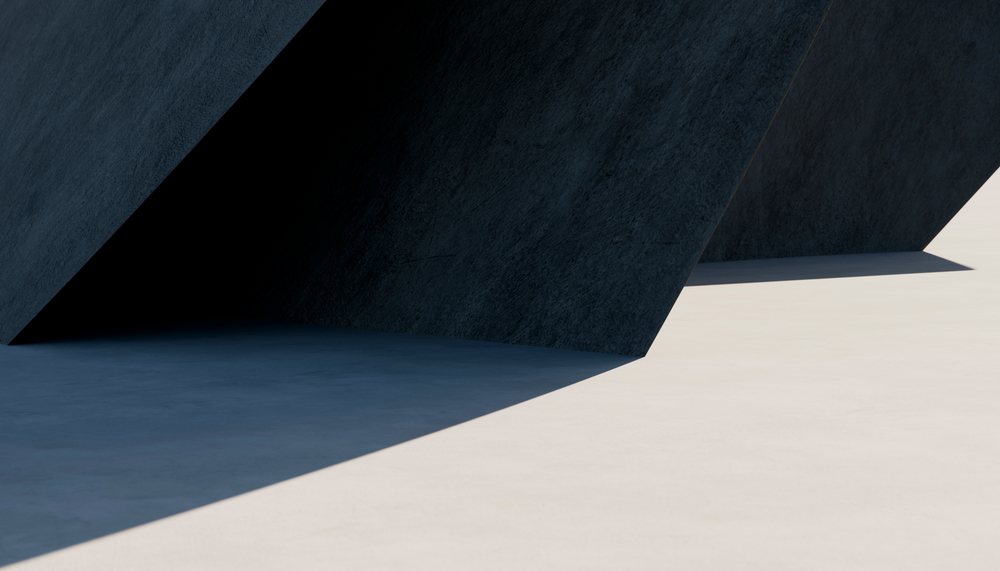 Modern concrete structure casting shadows on a light outdoor floor