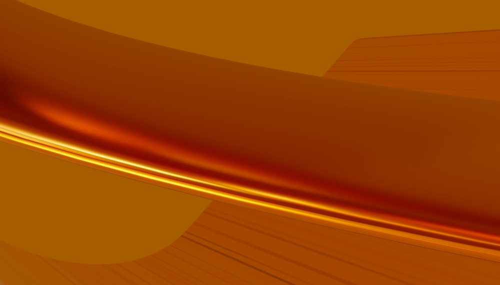Golden viscous liquid flowing smoothly with shiny amber surface in close-up macro texture.