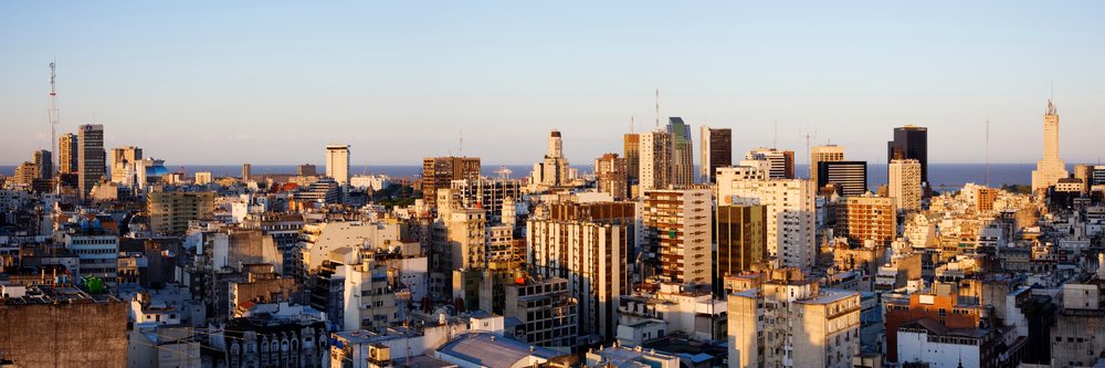 Sunset over Buenos Aires cityscape with high-rise buildings and Atlantic Ocean in the background.