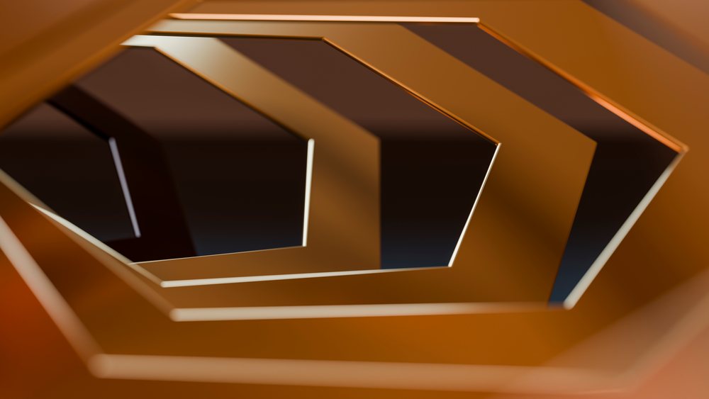 Close-up of overlapping hexagonal metal rings in orange tones forming an abstract geometric pattern with reflective metallic surfaces.