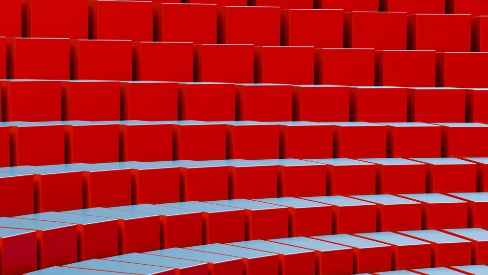Rows of red cubes with smooth, shiny surfaces form an abstract geometric pattern in this 3D rendered image.