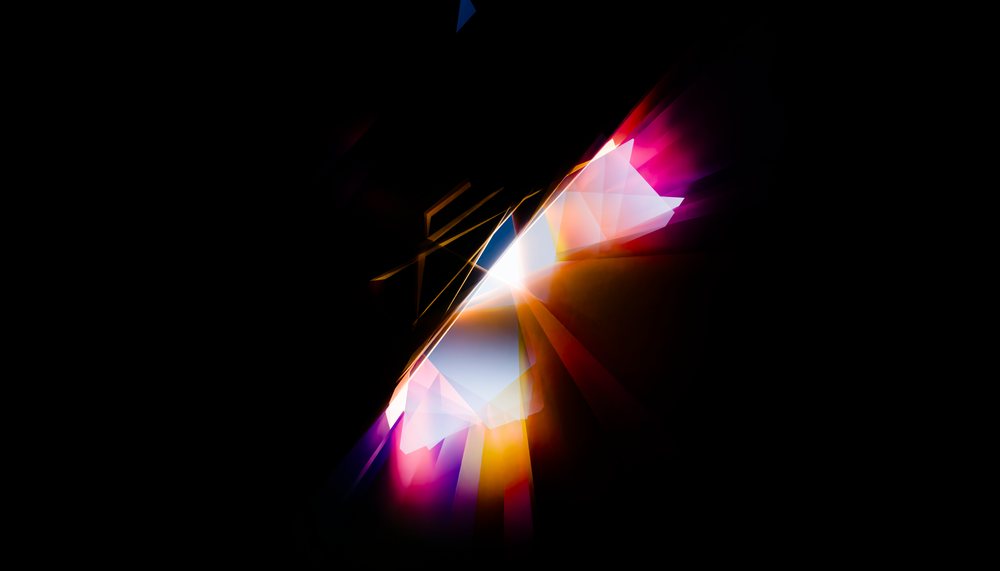 A digital abstract image featuring colorful geometric light shapes and vibrant streaks on a black background.