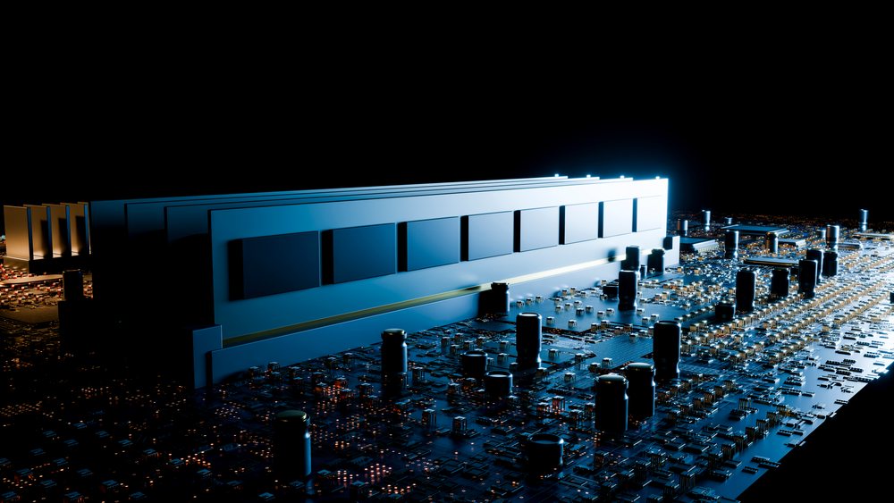 RAM module with capacitors and gold connectors mounted on a multi-layer printed circuit board against black background.