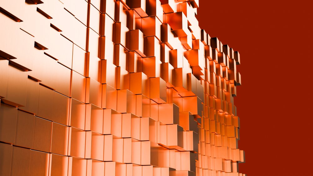 Abstract pattern of orange 3D geometric metallic blocks forming a modern architectural design.