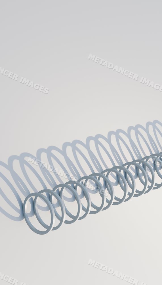 A metal coil casting repeating shadows on a white background